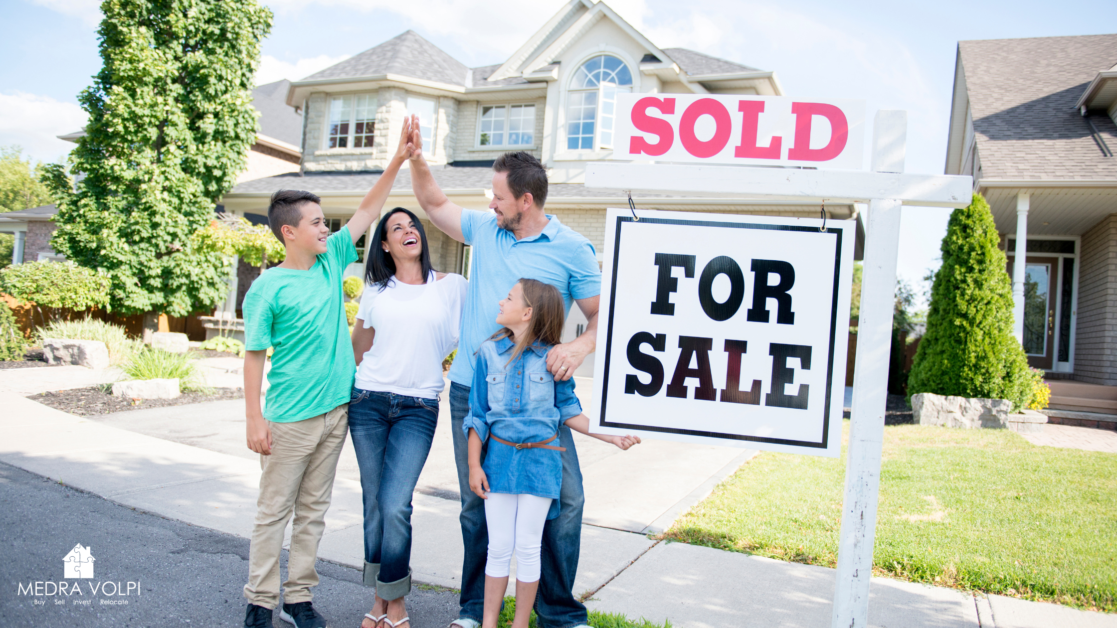 family standing in front of sold house