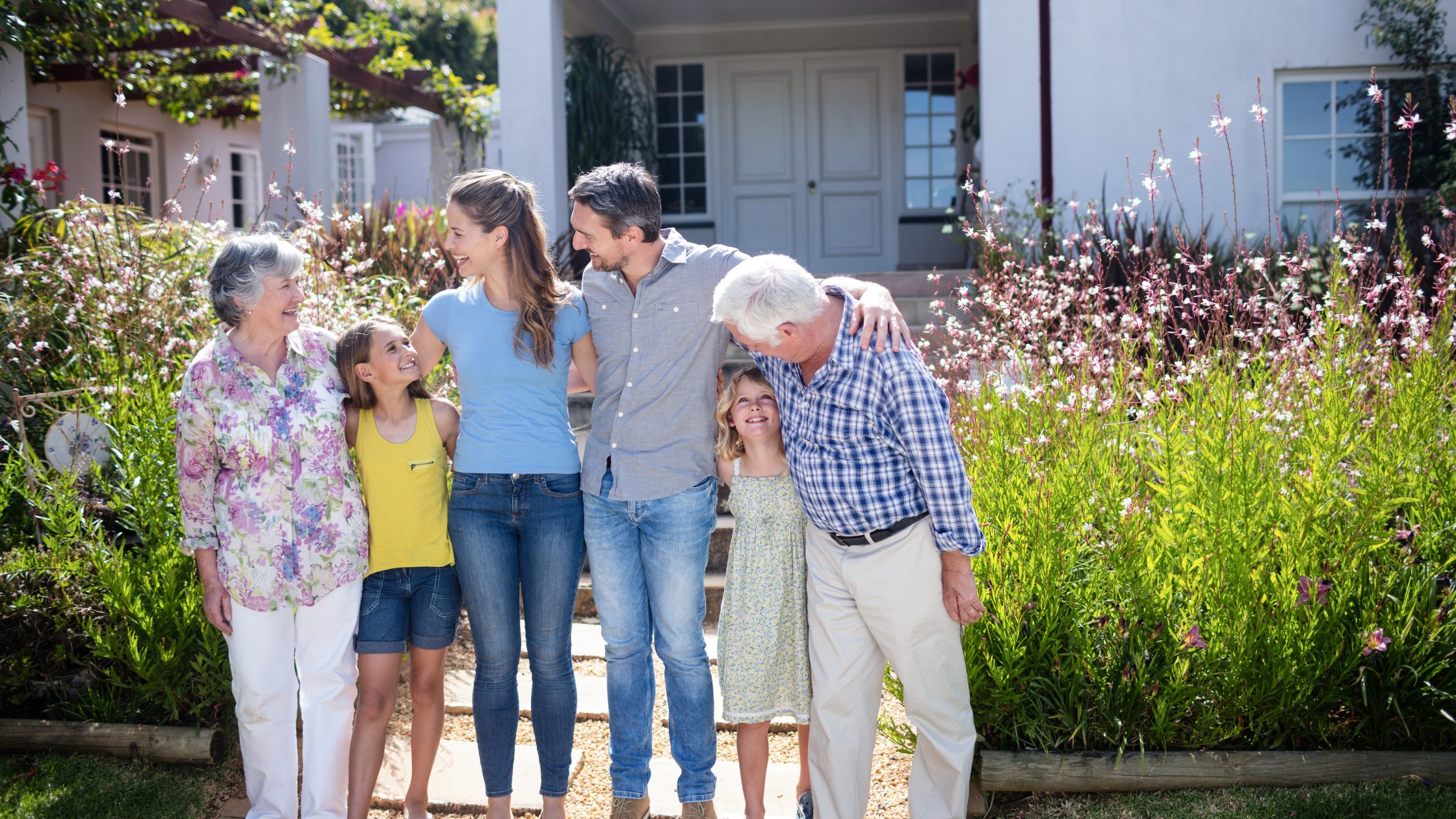 multigenerational family standing in front of a newly constructed home in Parker, Colorado
